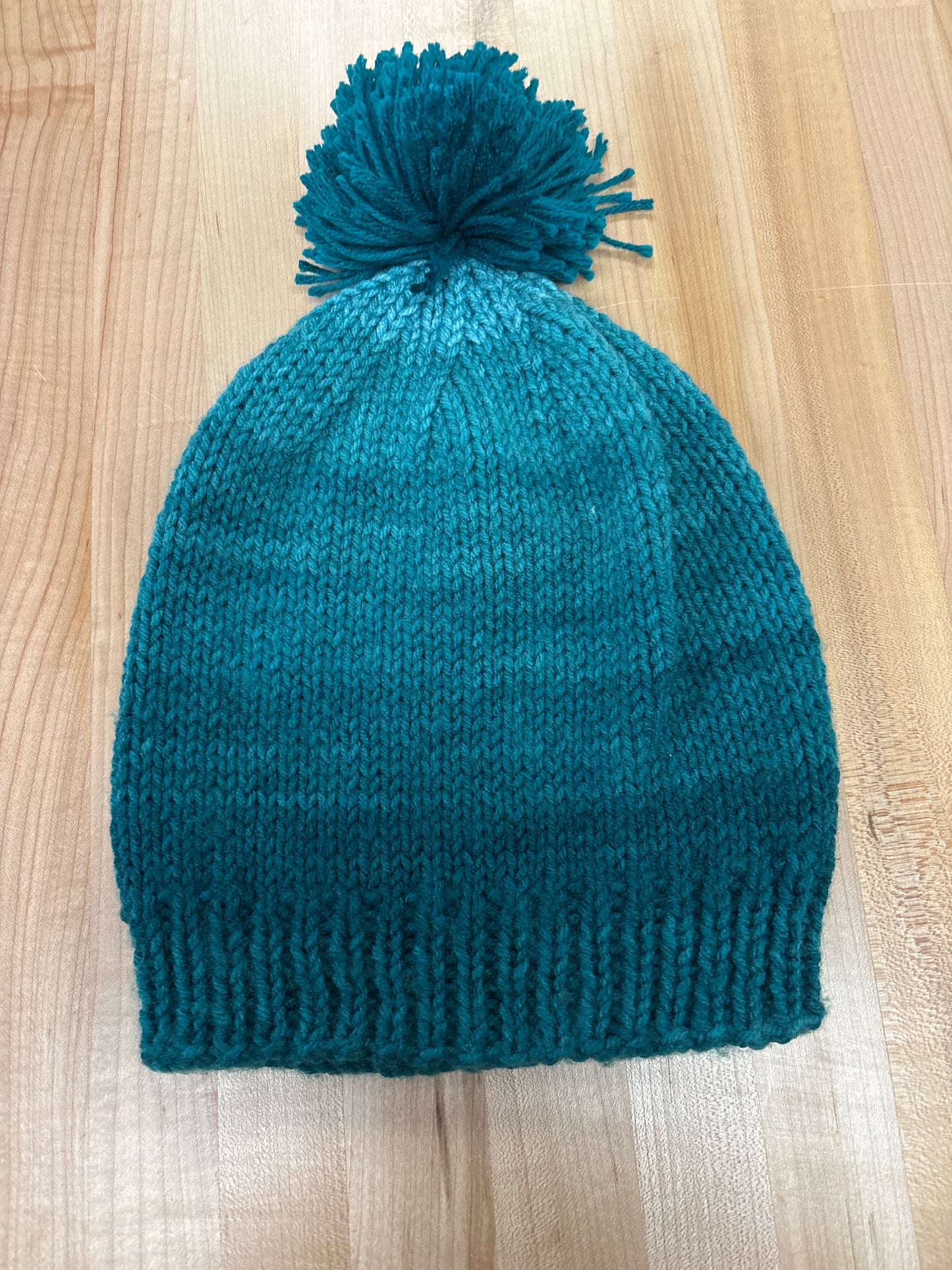 Hand knit winter hat with pom-pom