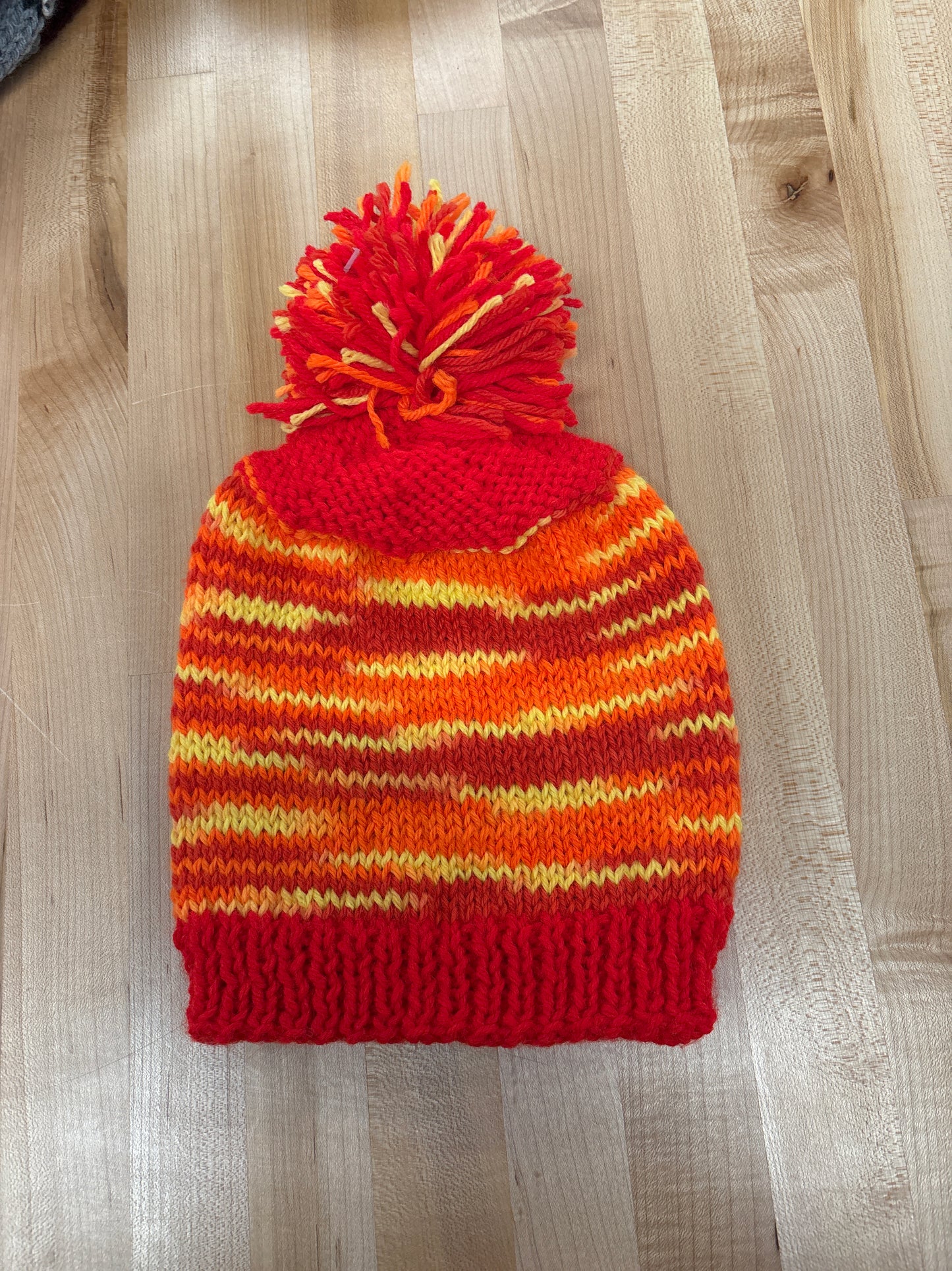 Hand knit winter hat with pom-pom