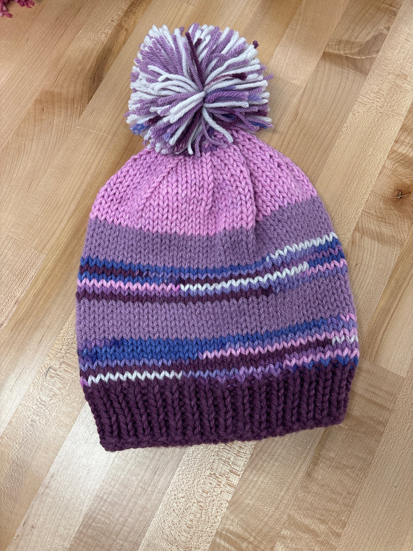 Hand knit winter hat with pom-pom