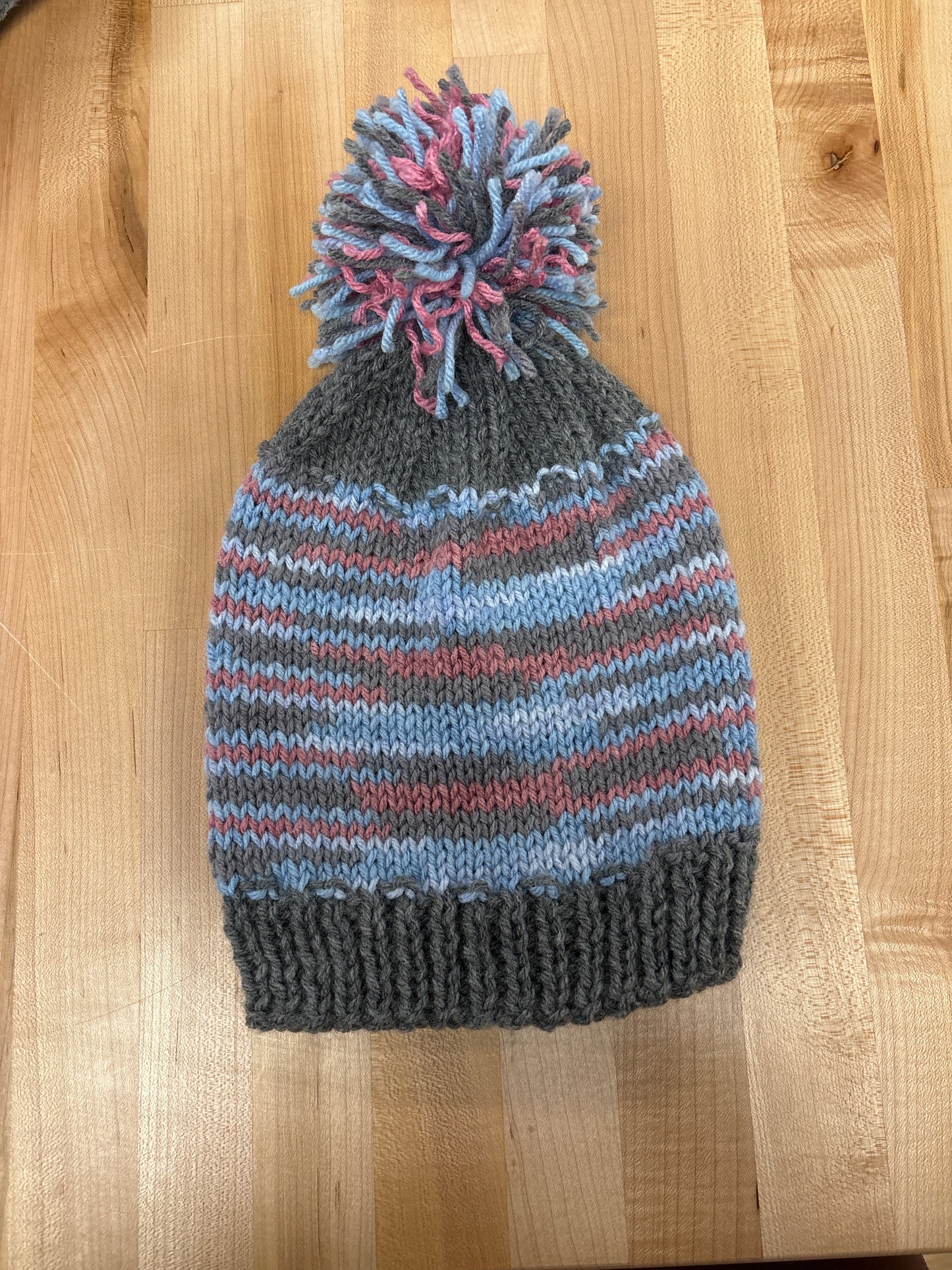 Hand knit winter hat with pom-pom