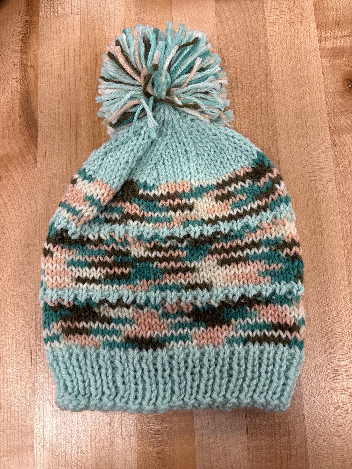 Hand knit winter hat with pom-pom