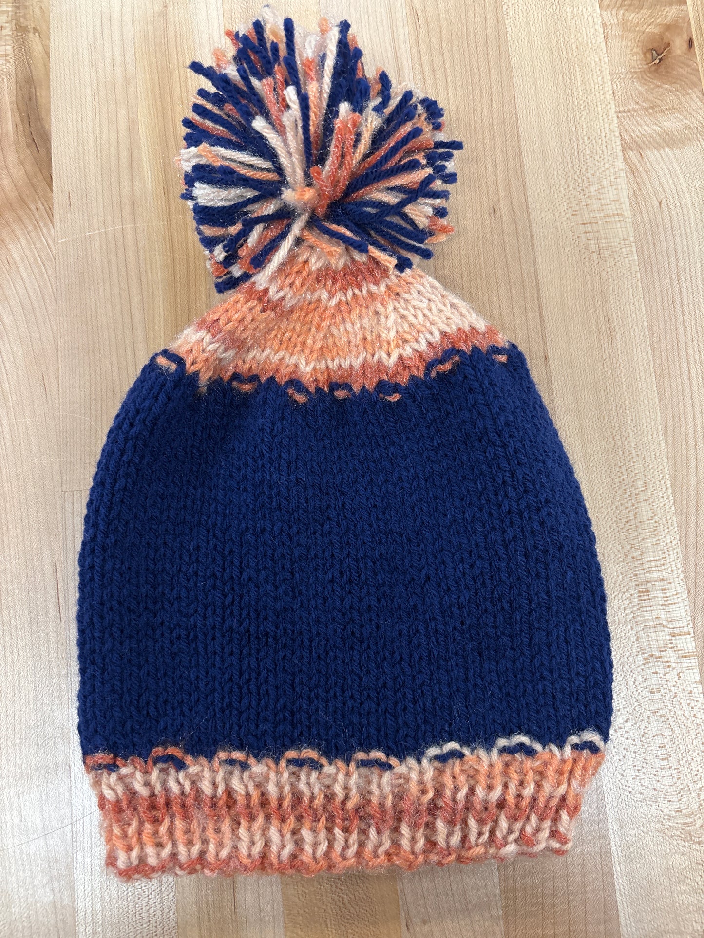 Hand knit winter hat with pom-pom