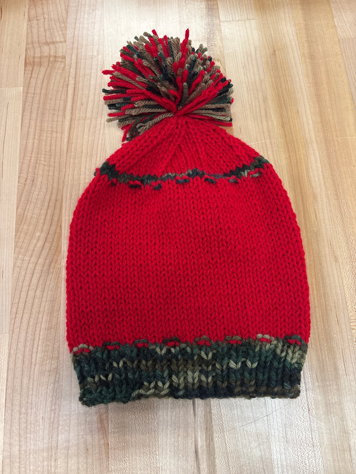 Hand knit winter hat with pom-pom