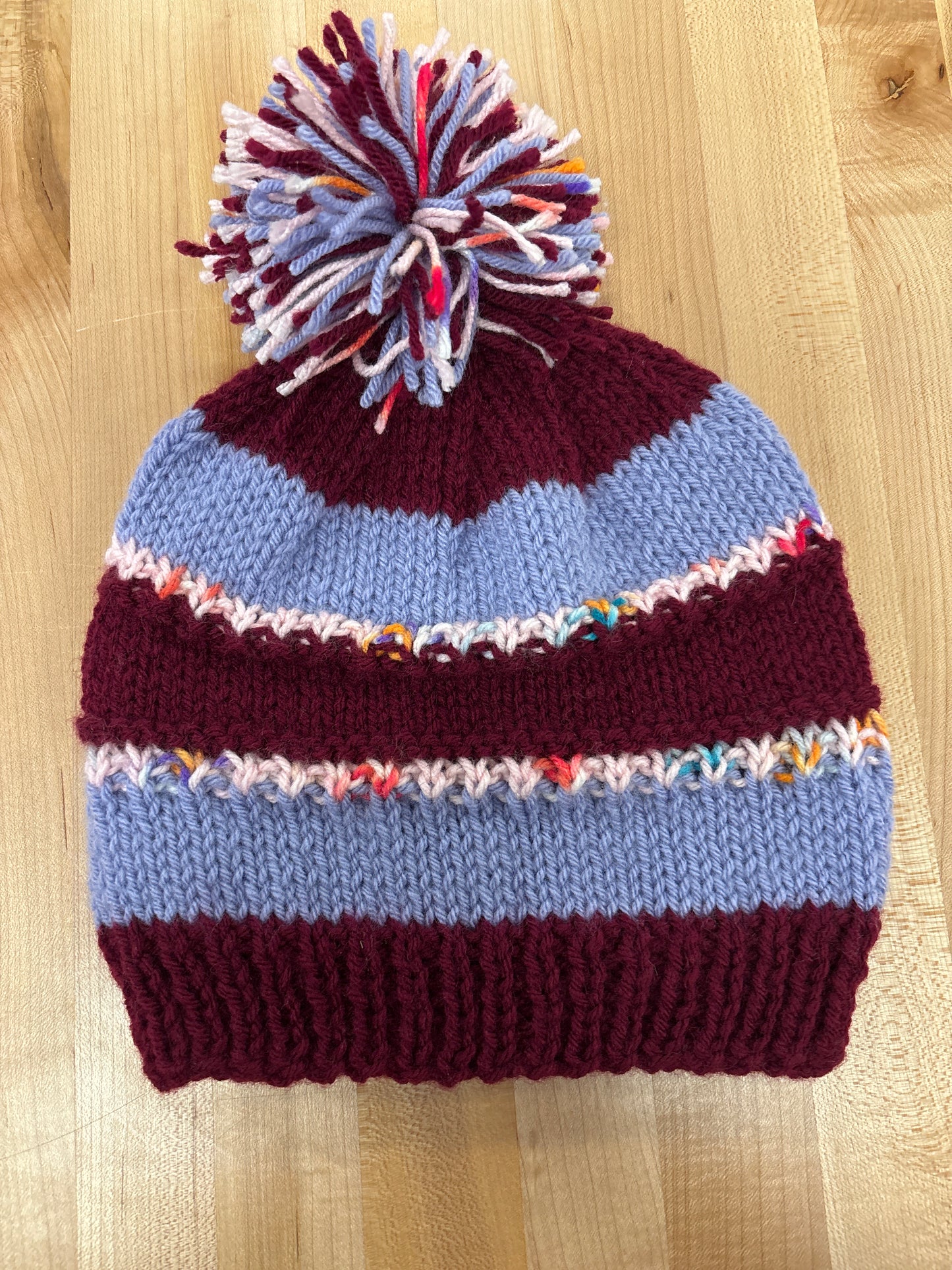 Hand knit winter hat with pom-pom