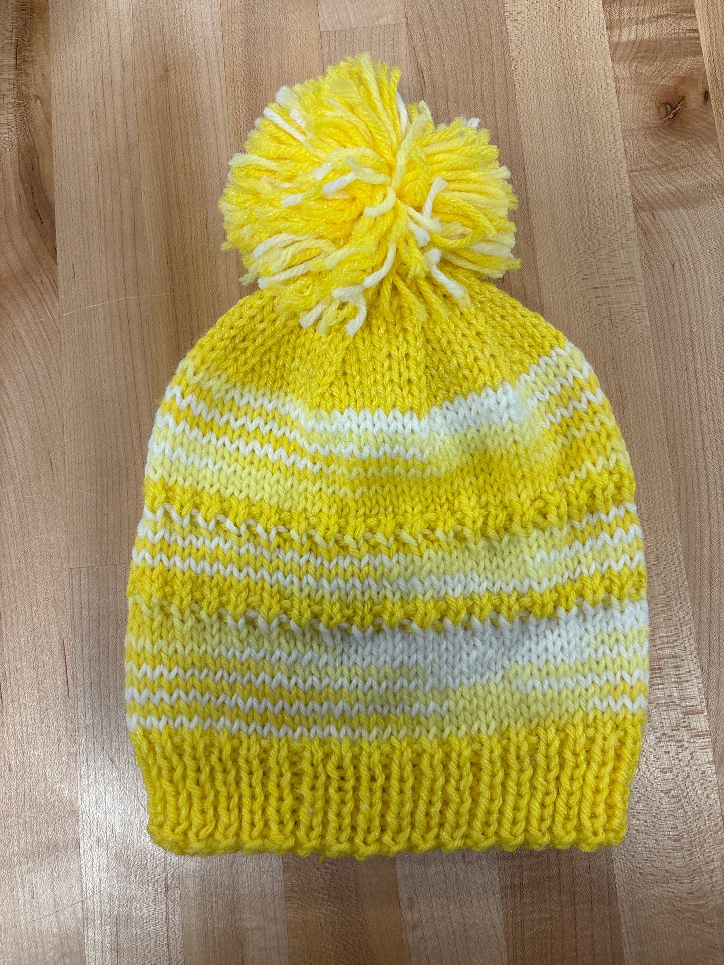 Hand knit winter hat with pom-pom