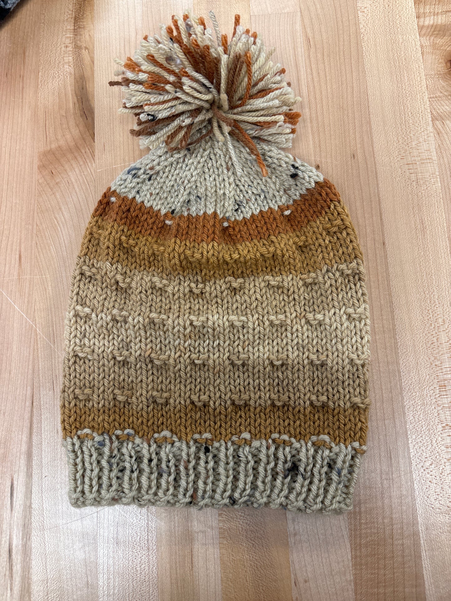 Hand knit winter hat with pom-pom