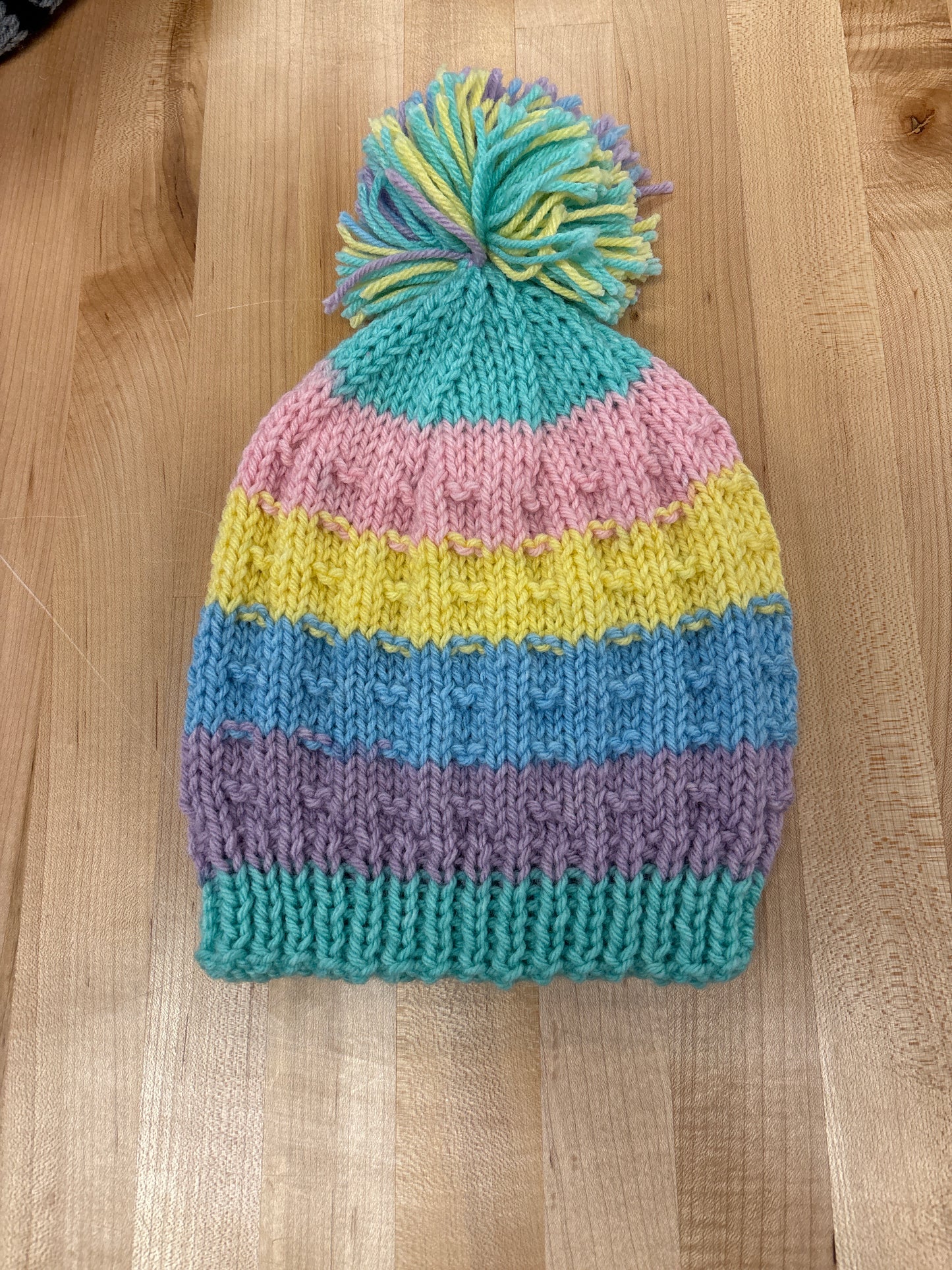 Hand knit winter hat with pom-pom