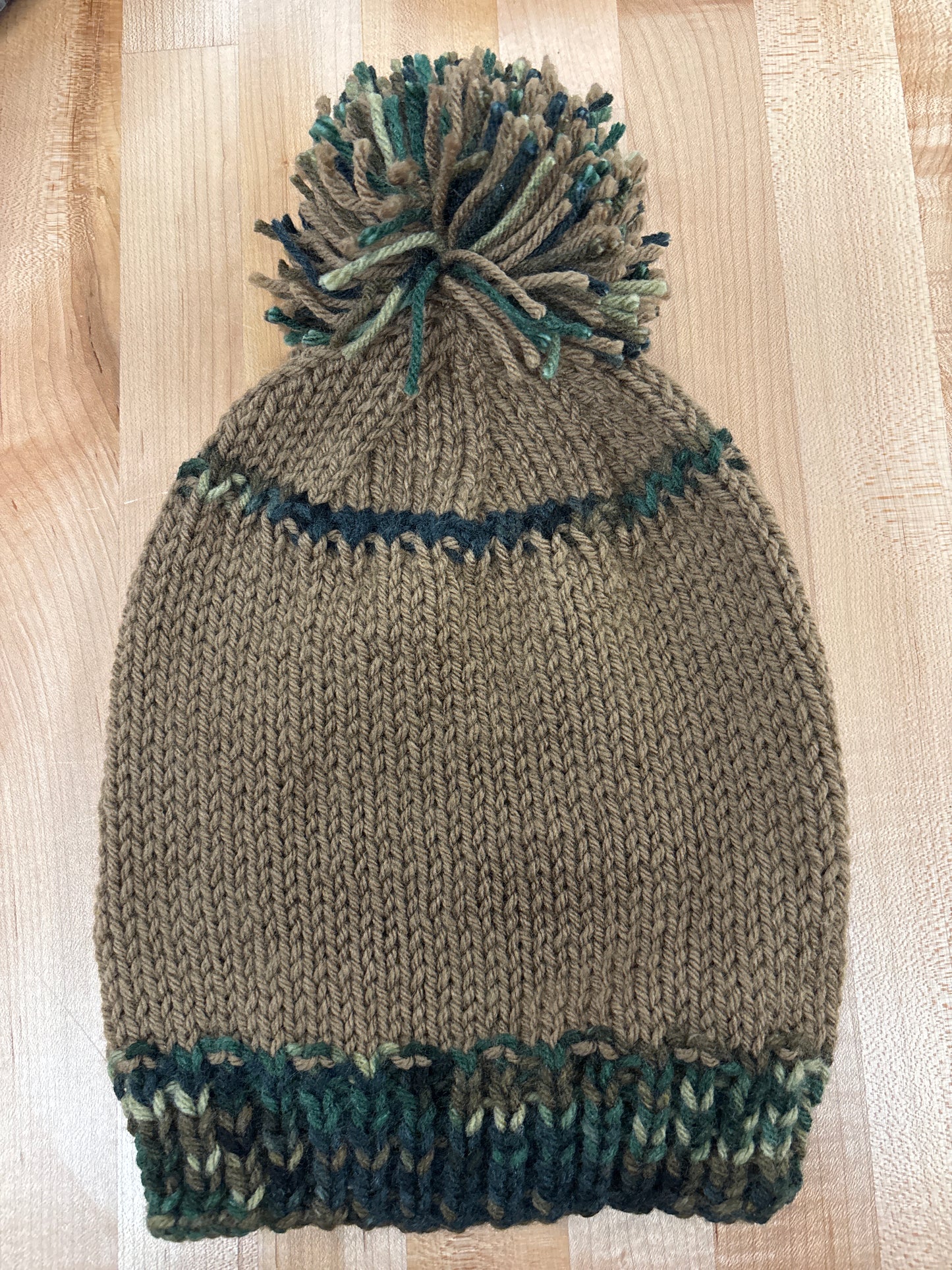 Hand knit winter hat with pom-pom