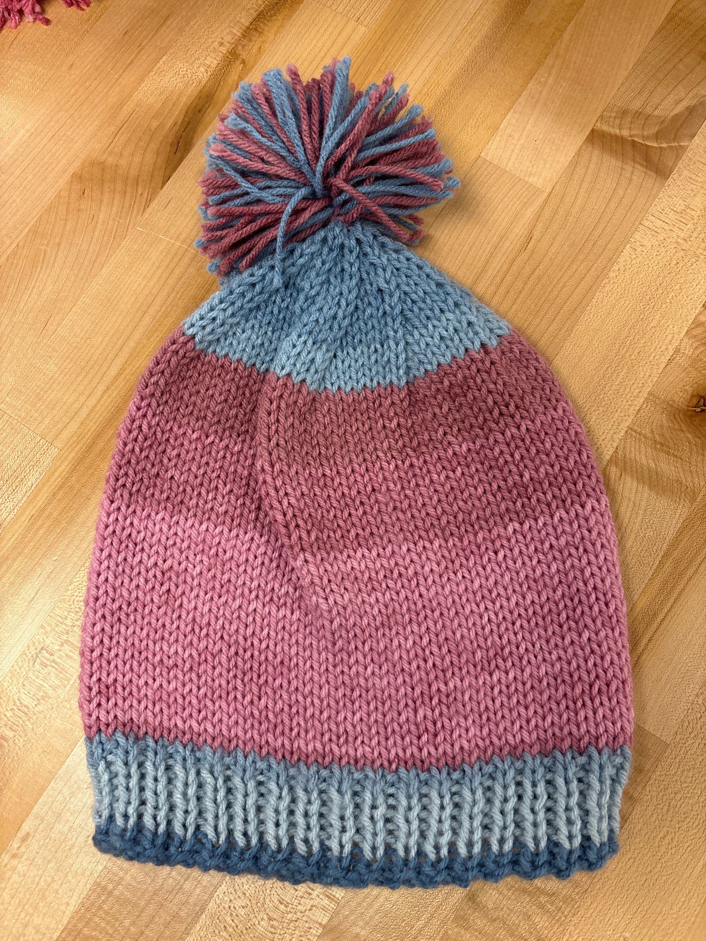 Hand knit winter hat with pom-pom