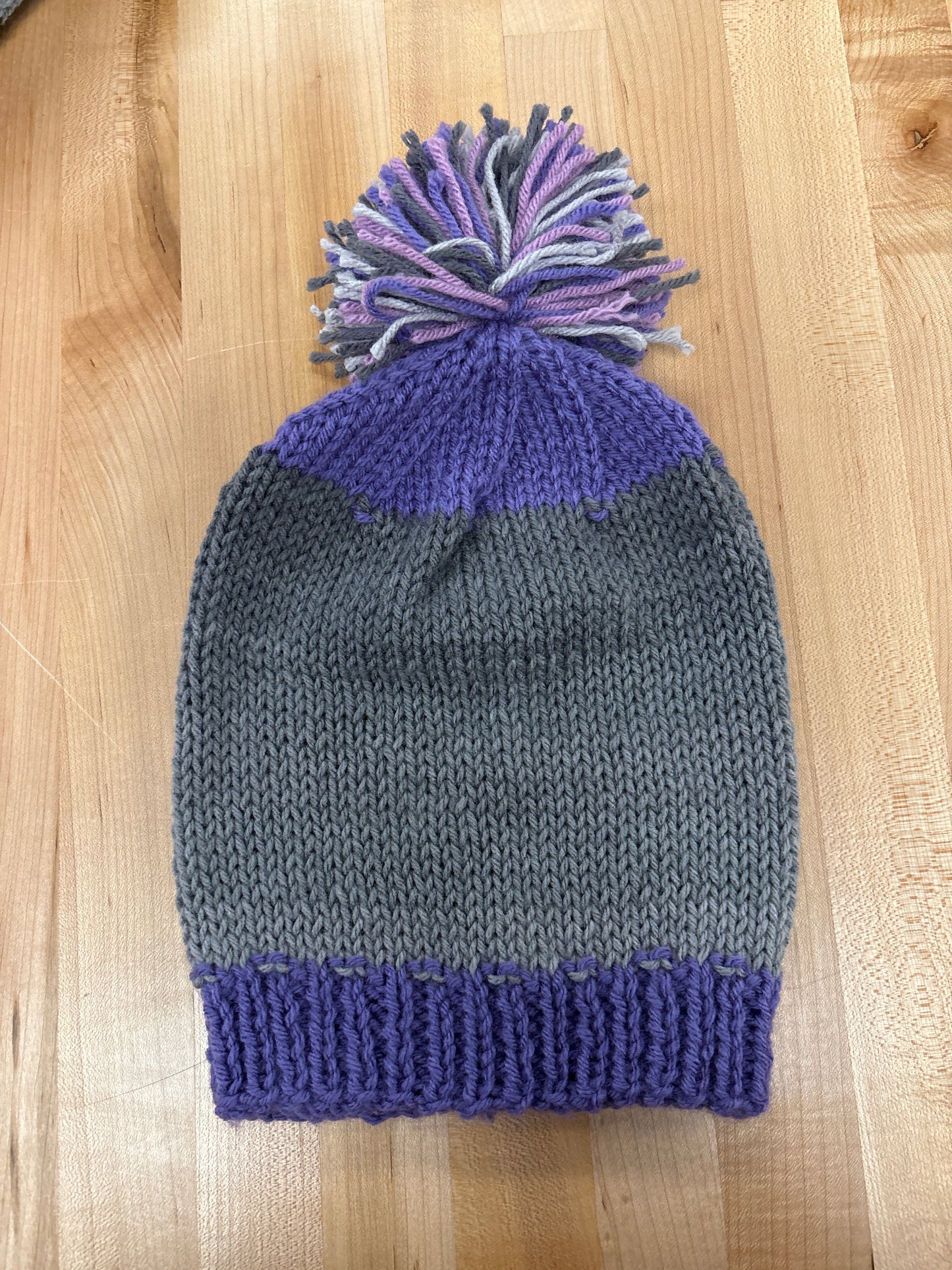 Hand knit winter hat with pom-pom