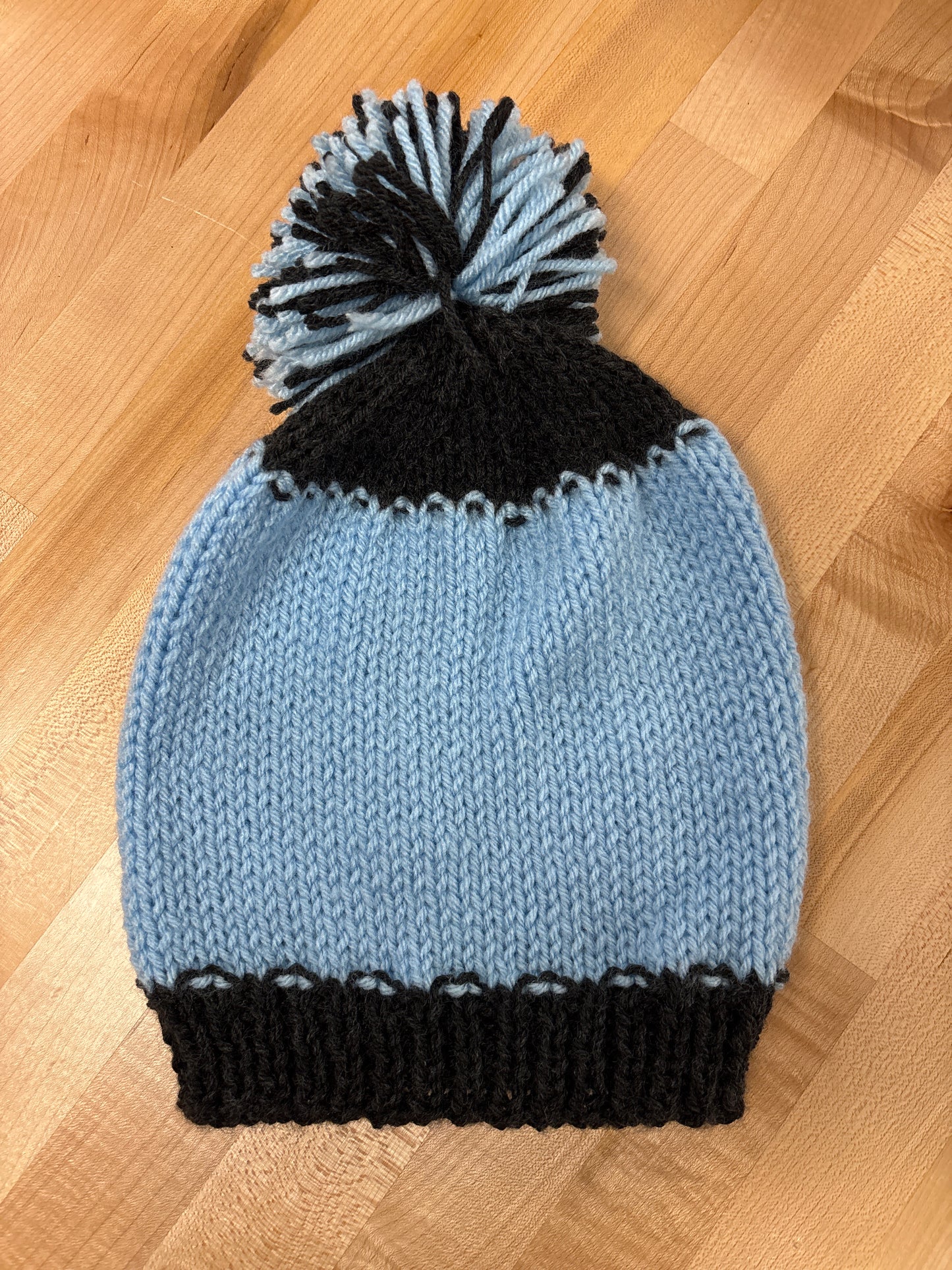 Hand knit winter hat with pom-pom