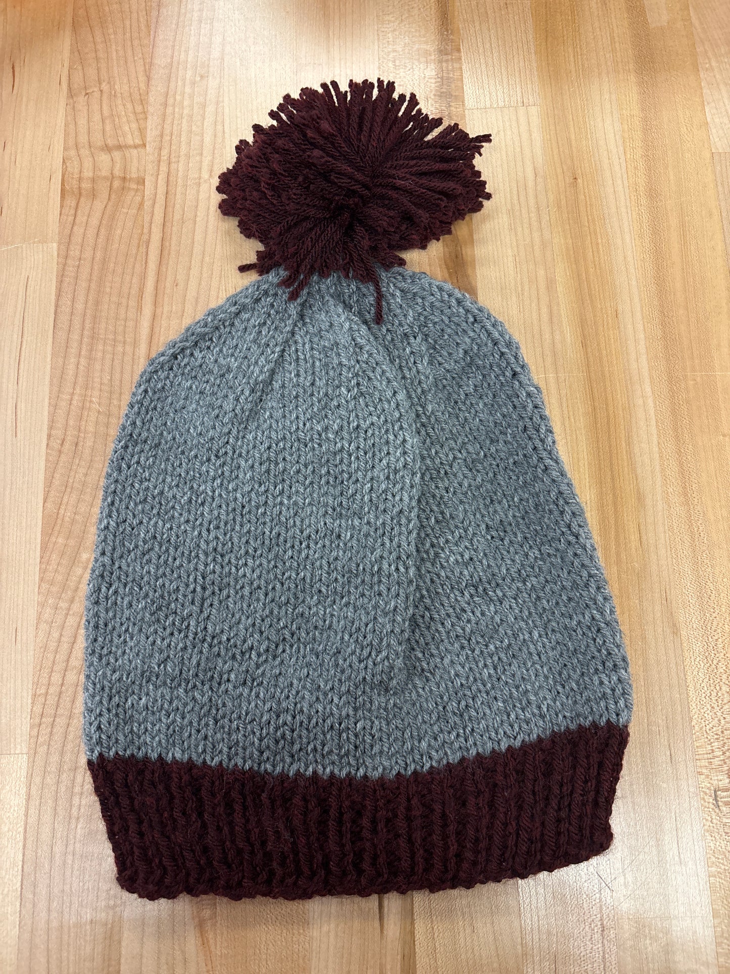 Hand knit winter hat with pom-pom