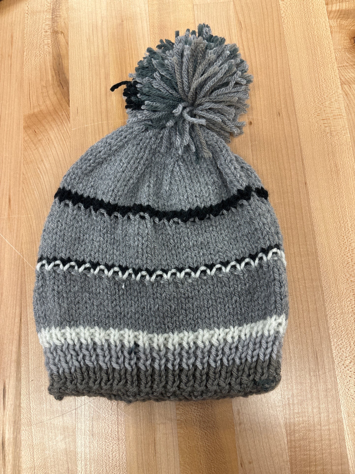 Hand knit winter hat with pom-pom