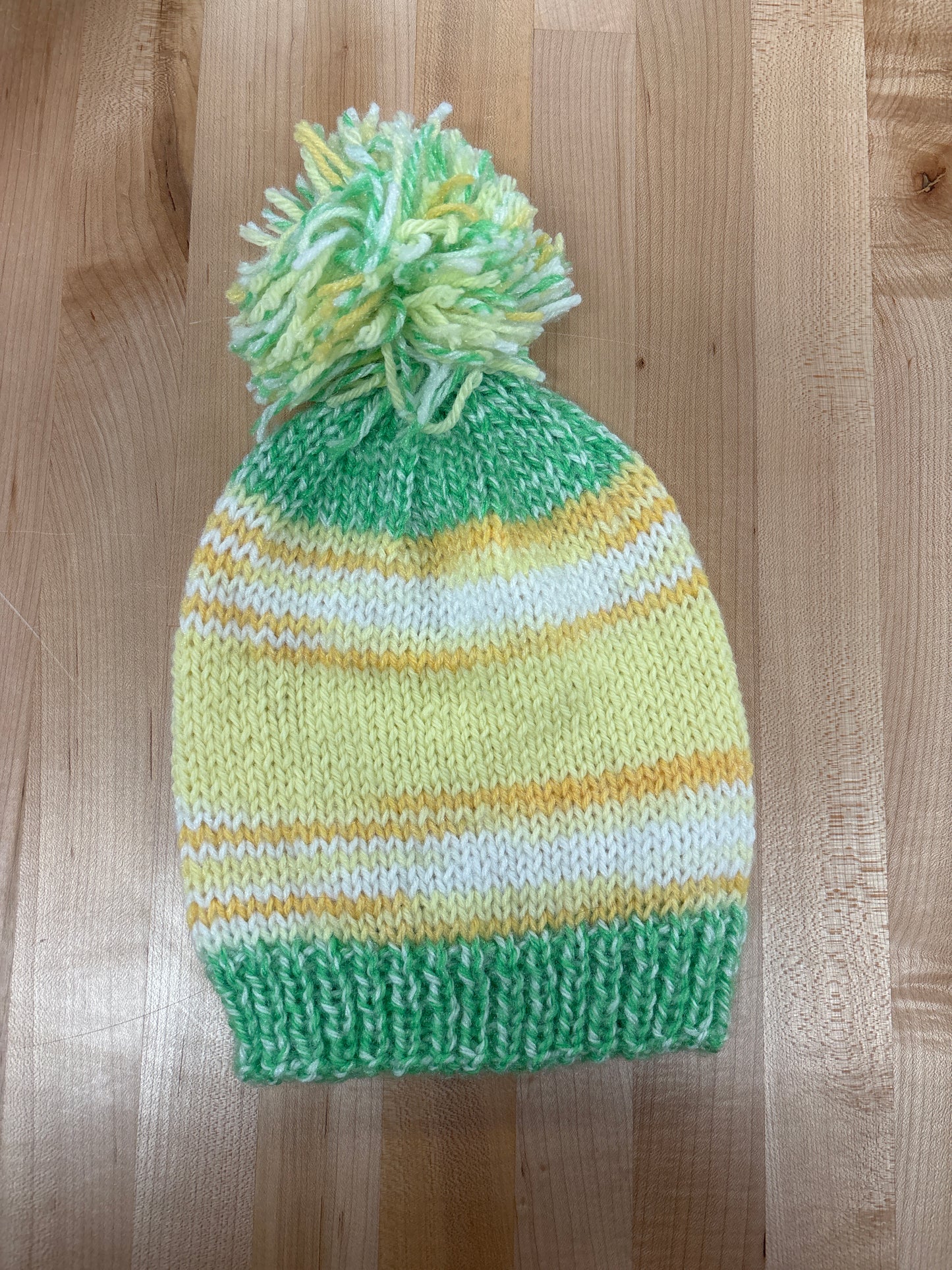 Hand knit winter hat with pom-pom