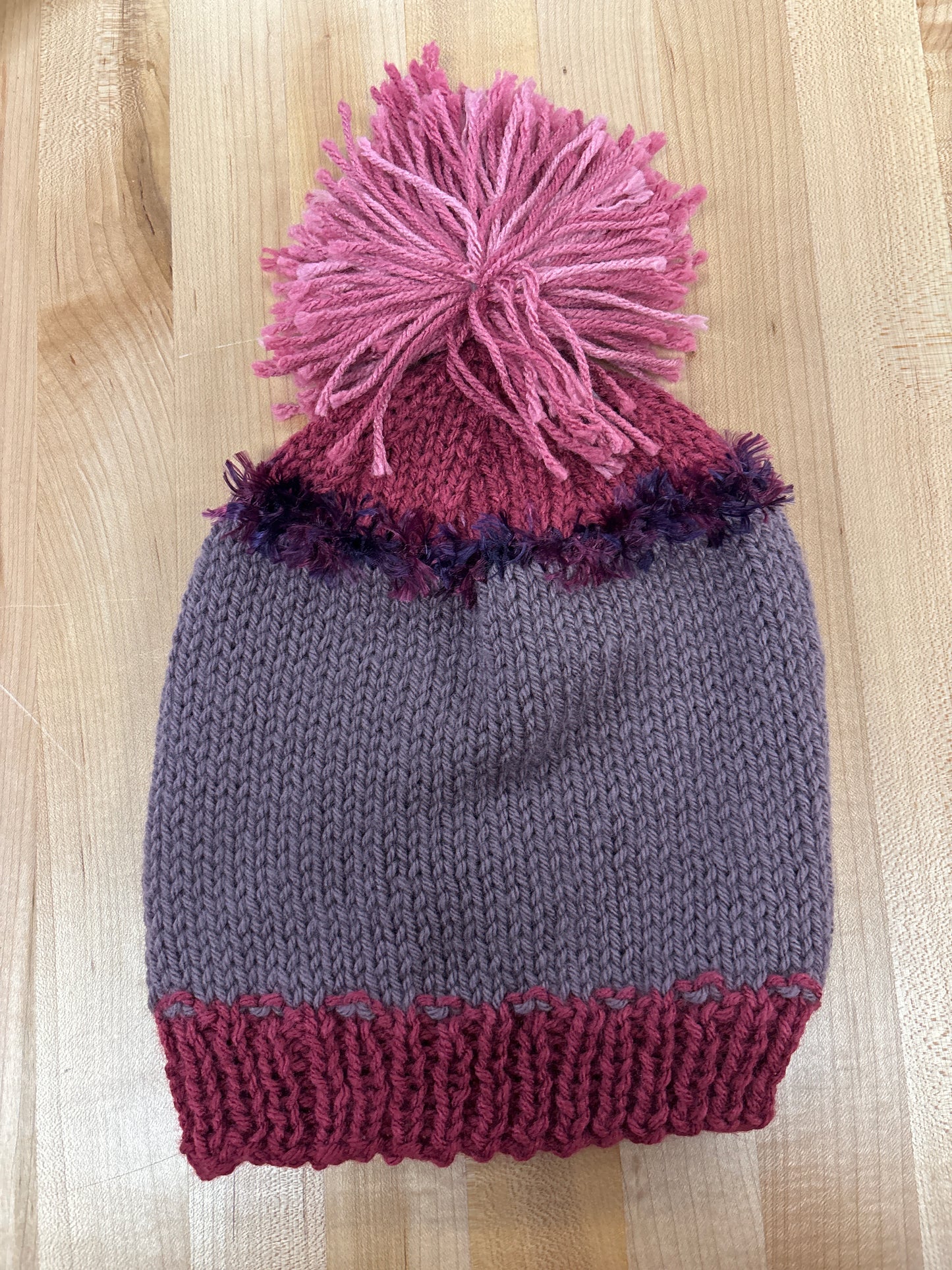 Hand knit winter hat with pom-pom