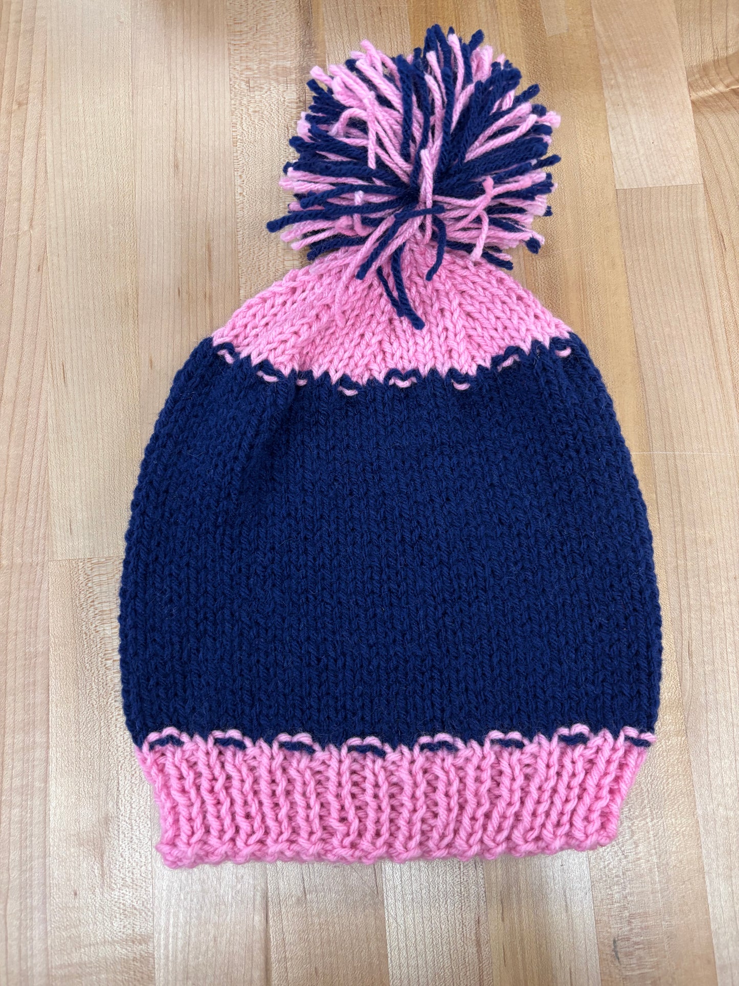 Hand knit winter hat with pom-pom