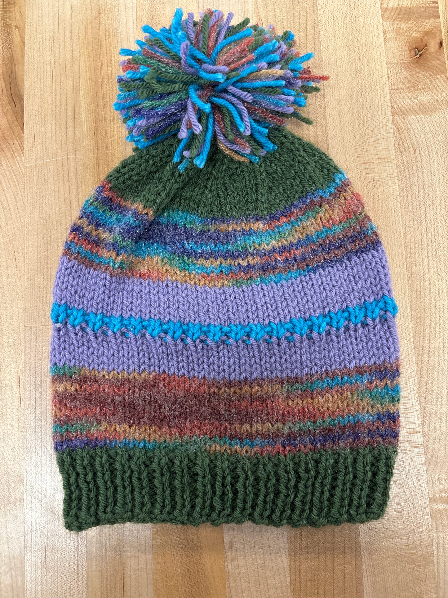 Hand knit winter hat with pom-pom