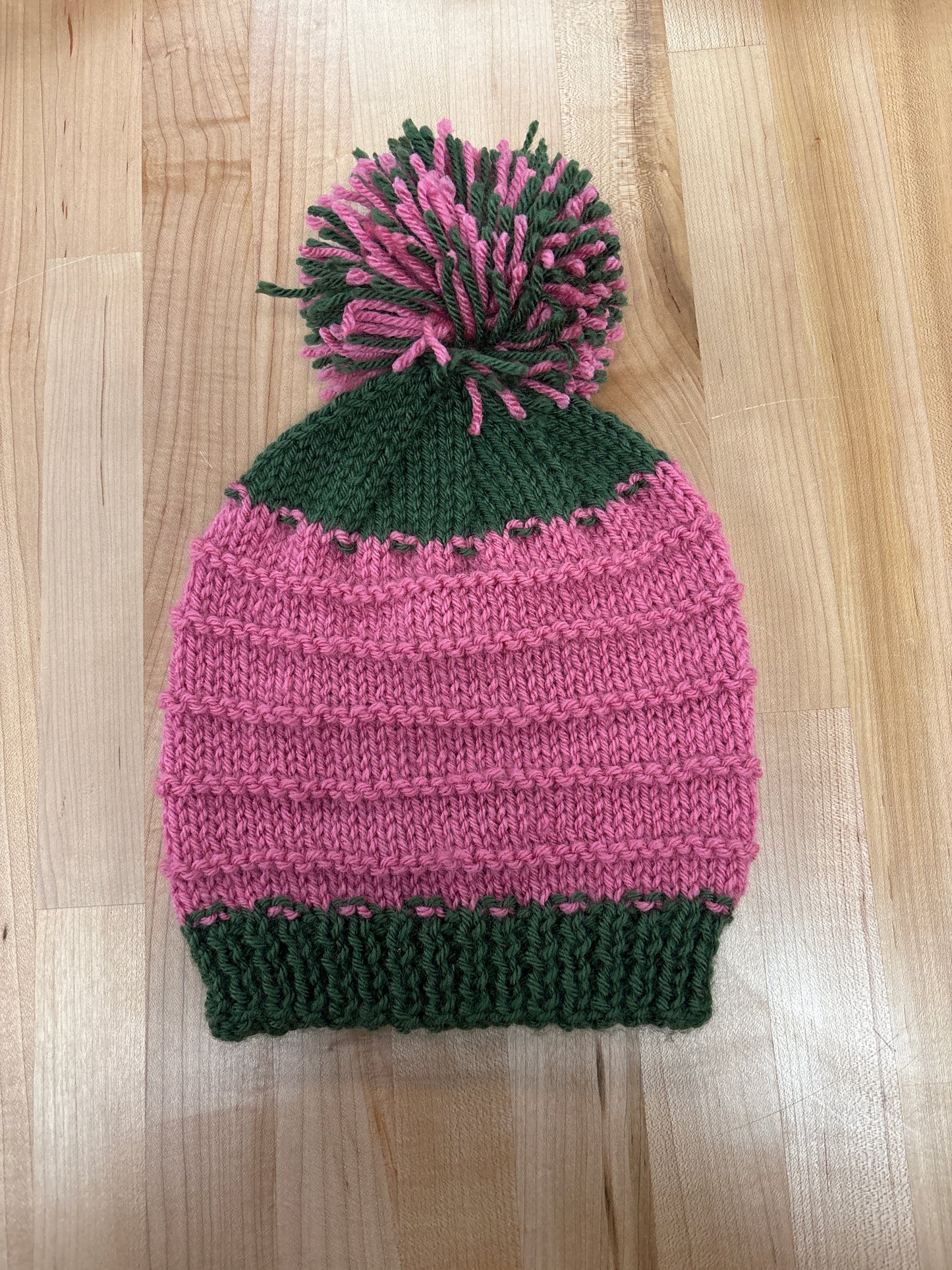 Hand knit winter hat with pom-pom