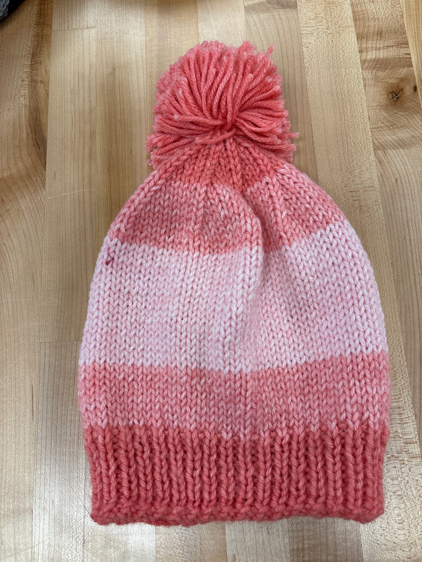 Hand knit winter hat with pom-pom