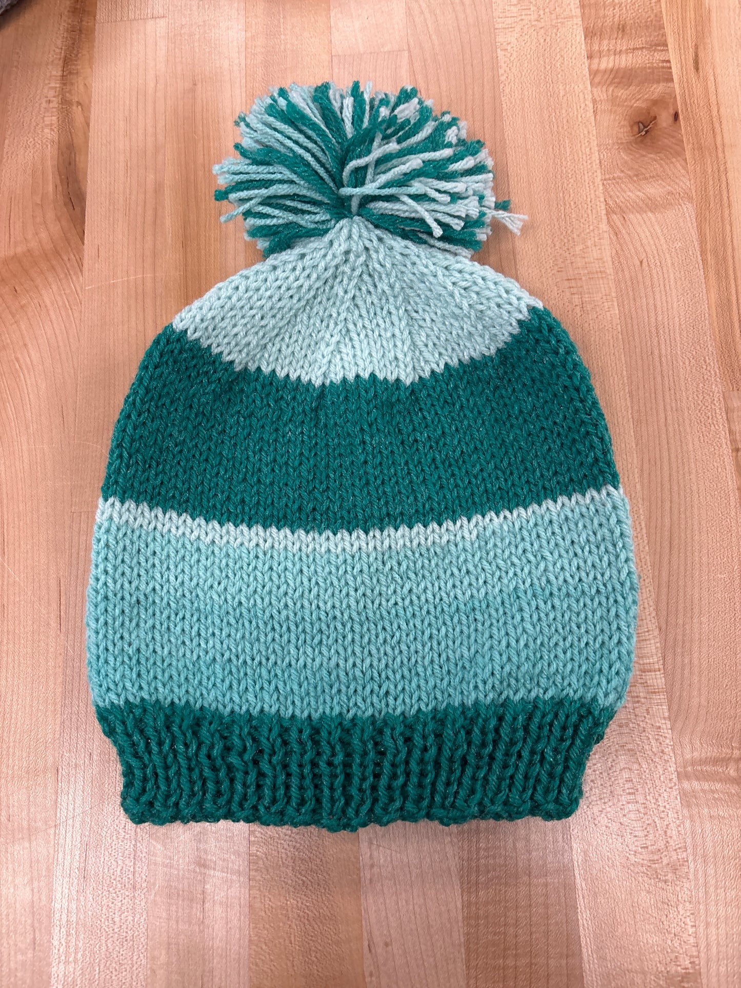 Hand knit winter hat with pom-pom