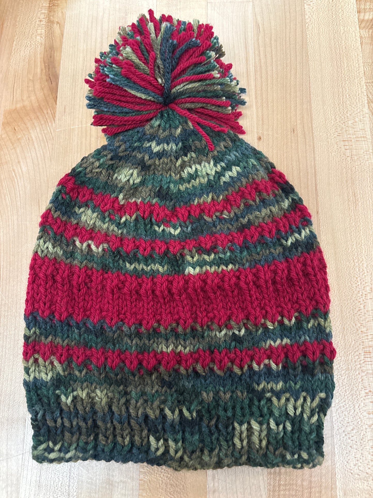 Hand knit winter hat with pom-pom