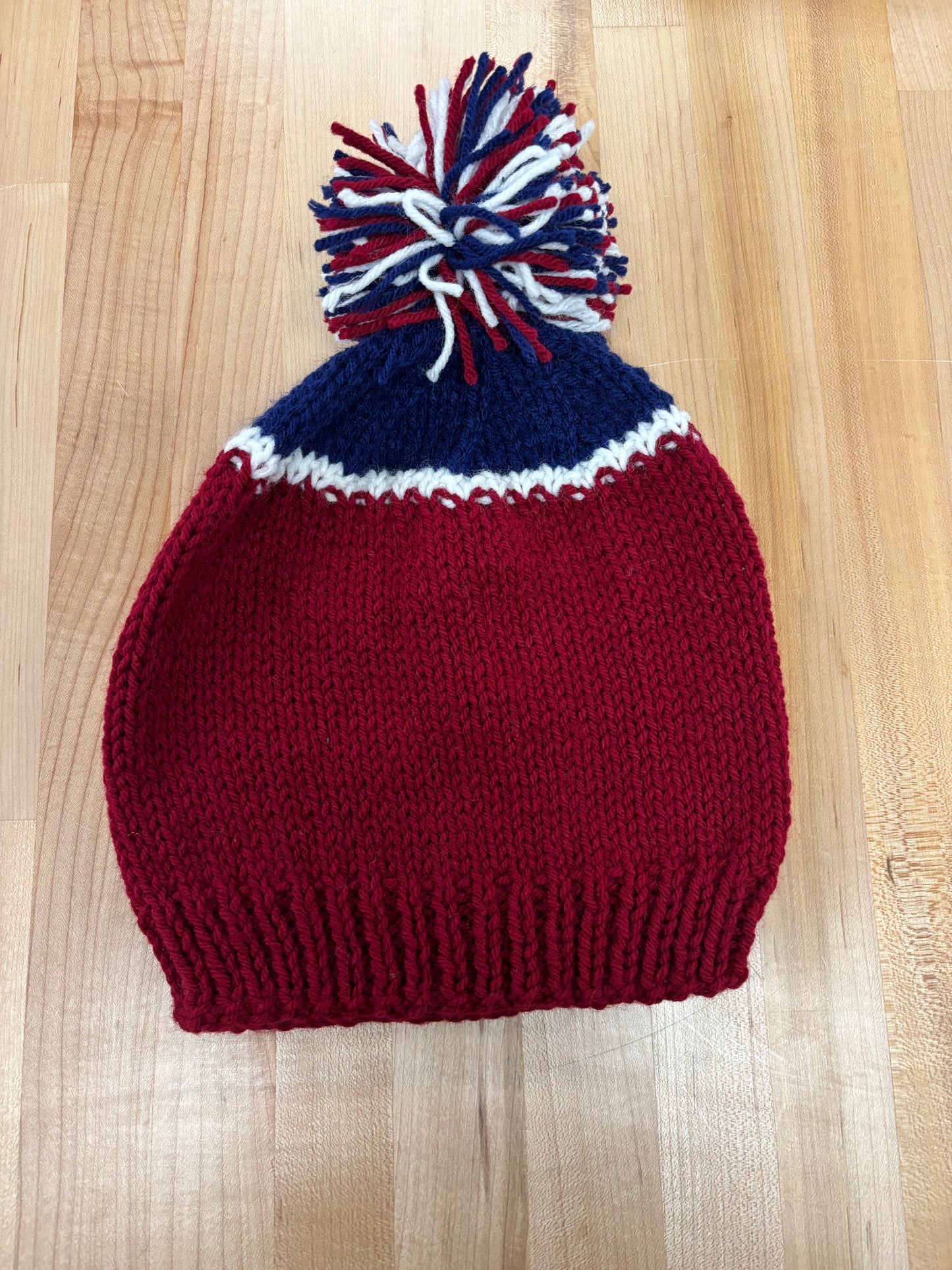 Hand knit winter hat with pom-pom