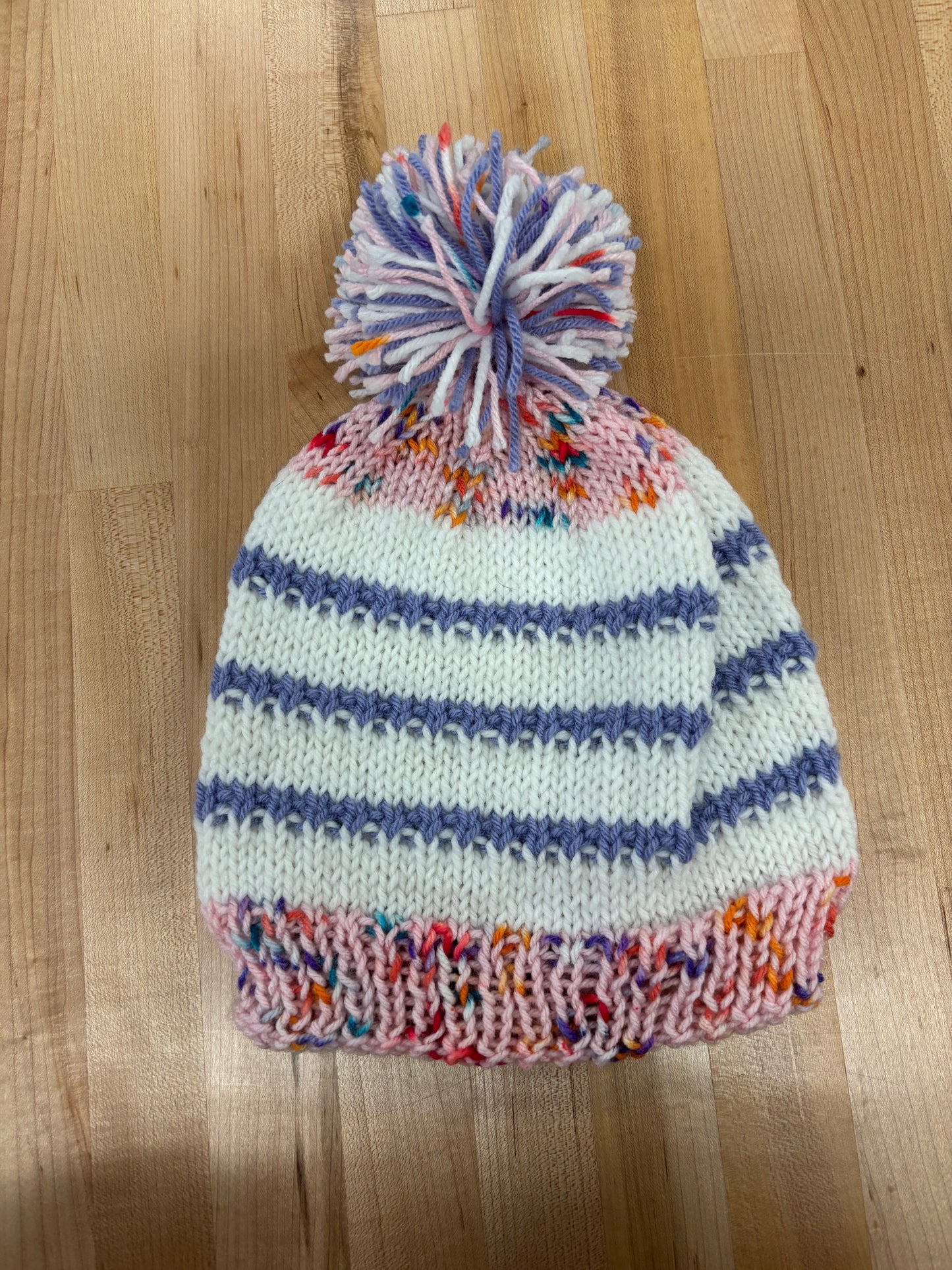 Hand knit winter hat with pom-pom