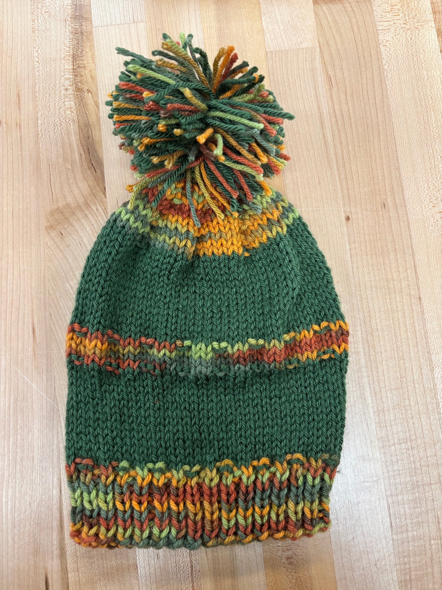 Hand knit winter hat with pom-pom