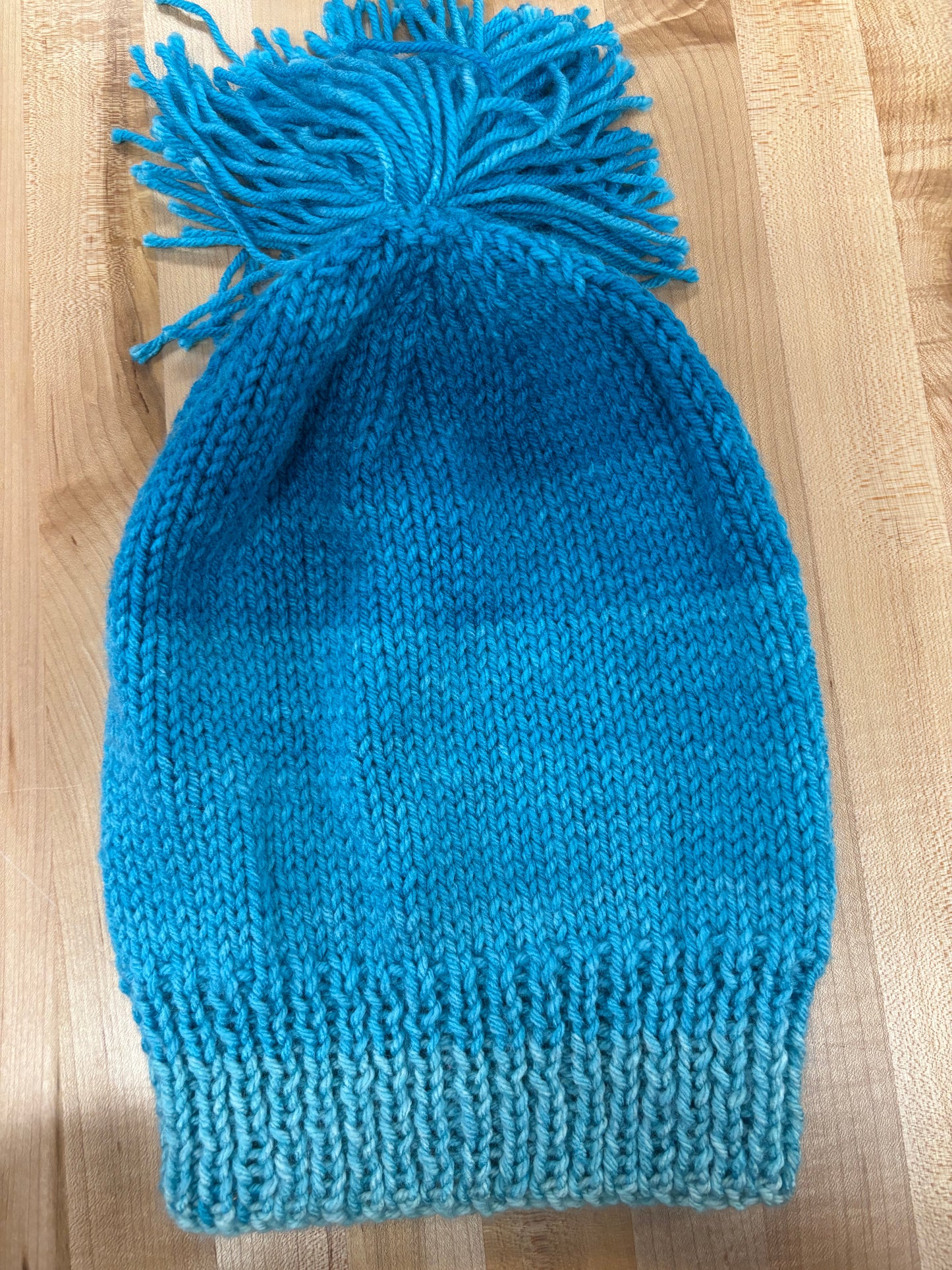 Hand knit winter hat with pom-pom