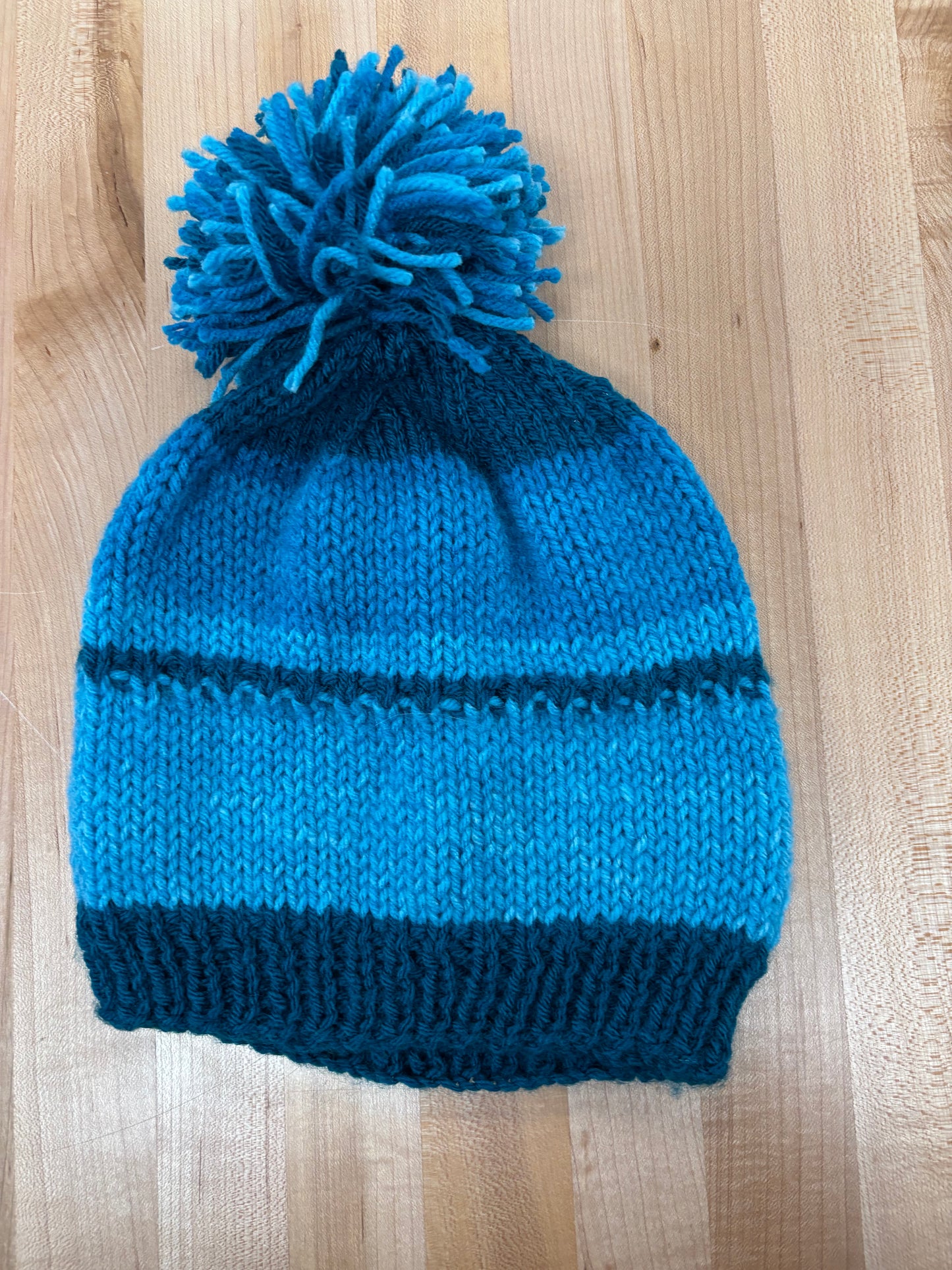 Hand knit winter hat with pom-pom