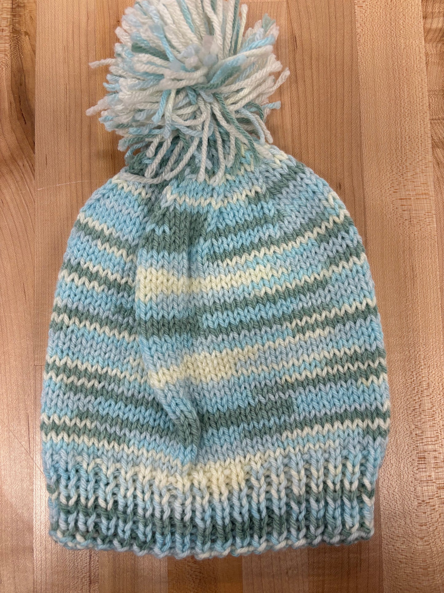 Hand knit winter hat with pom-pom