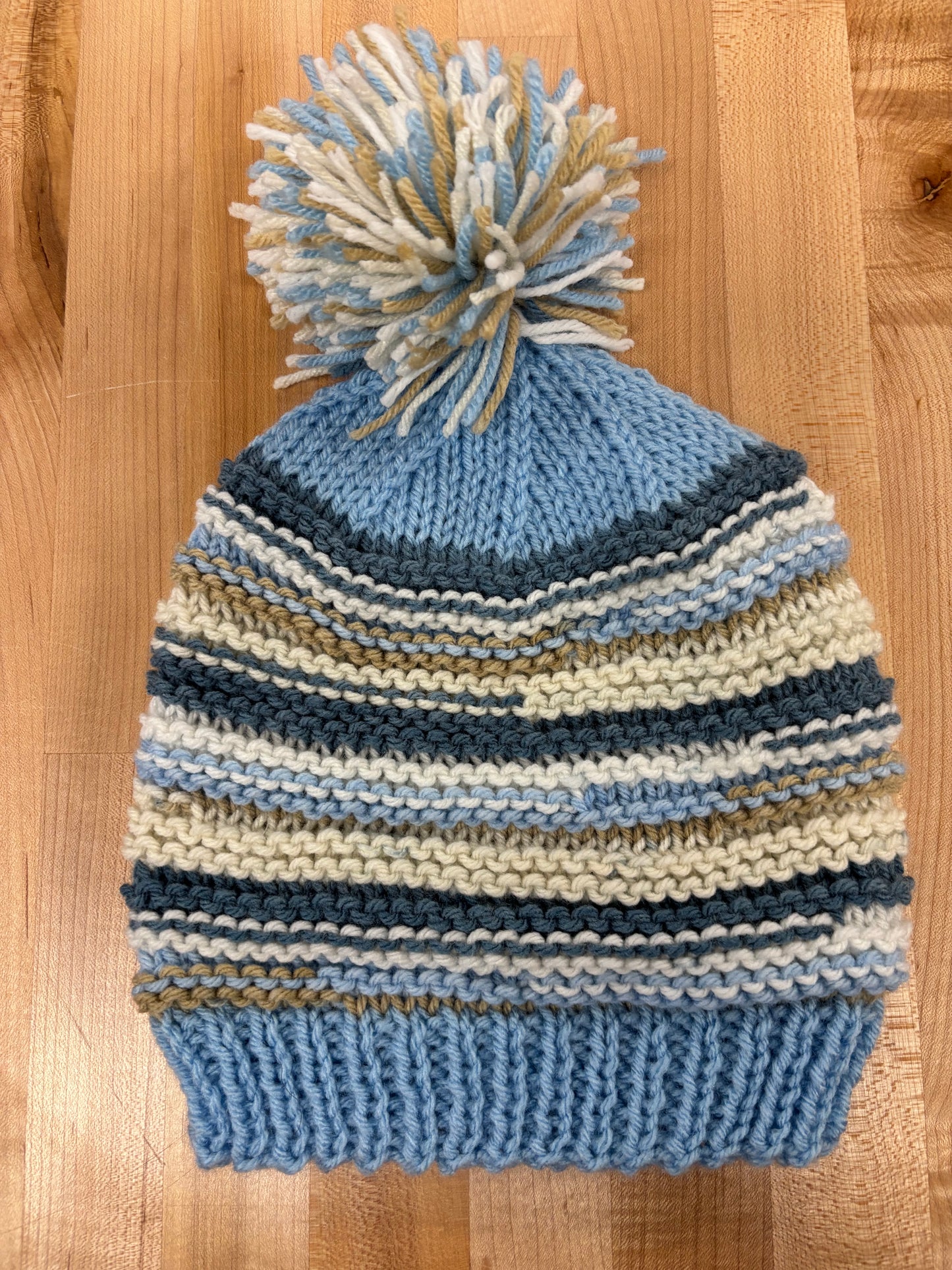 Hand knit winter hat with pom-pom