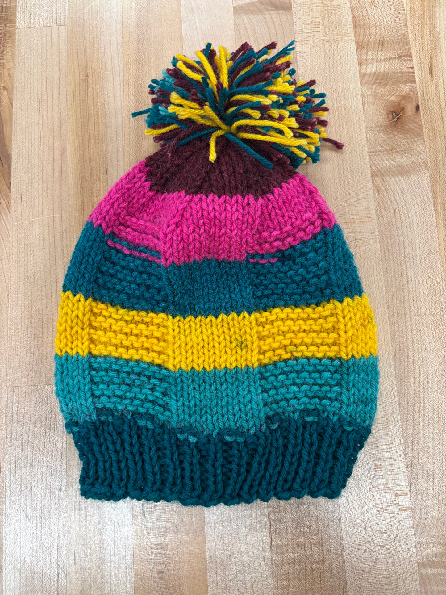 Hand knit winter hat with pom-pom