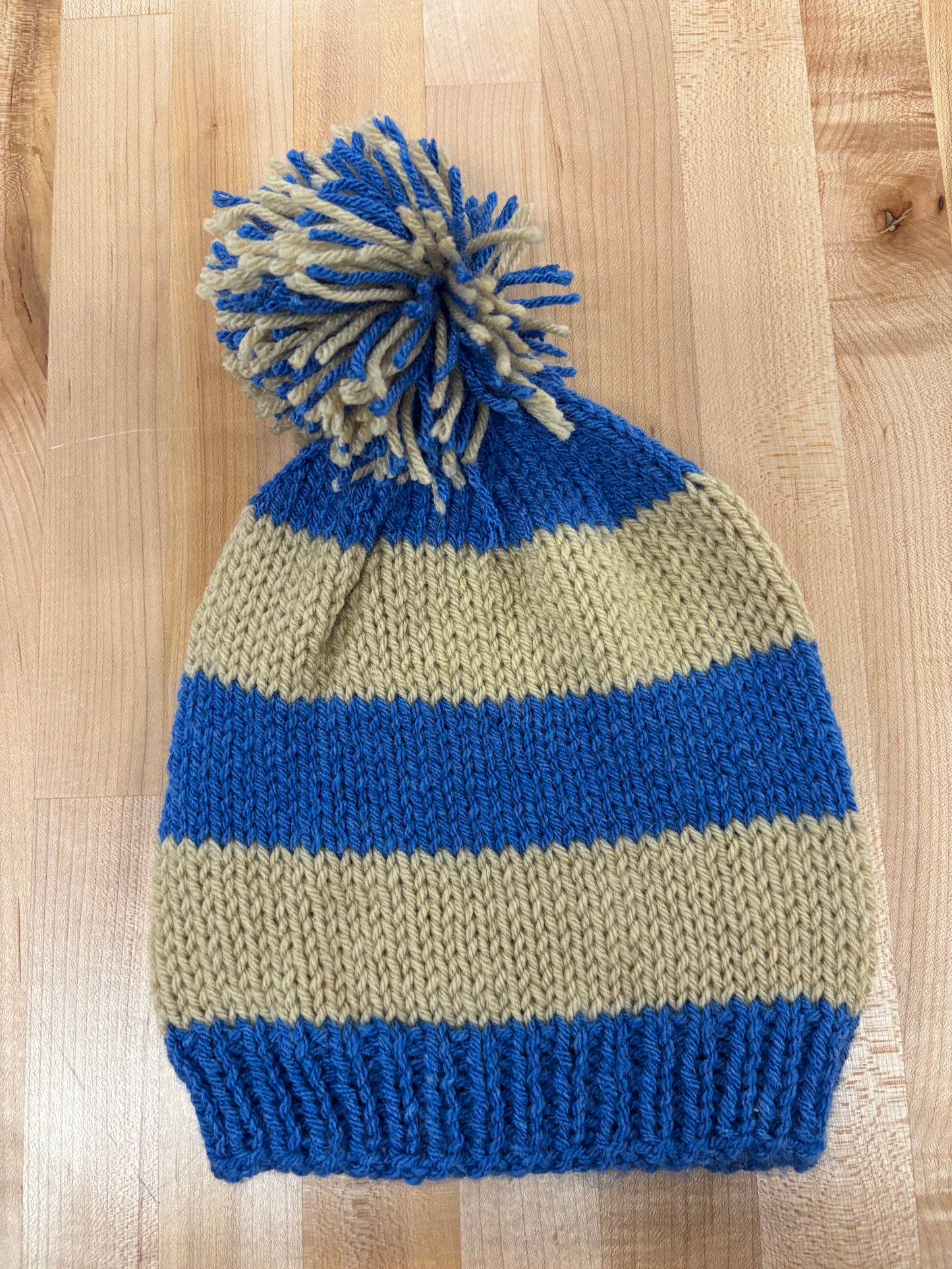 Hand knit winter hat with pom-pom