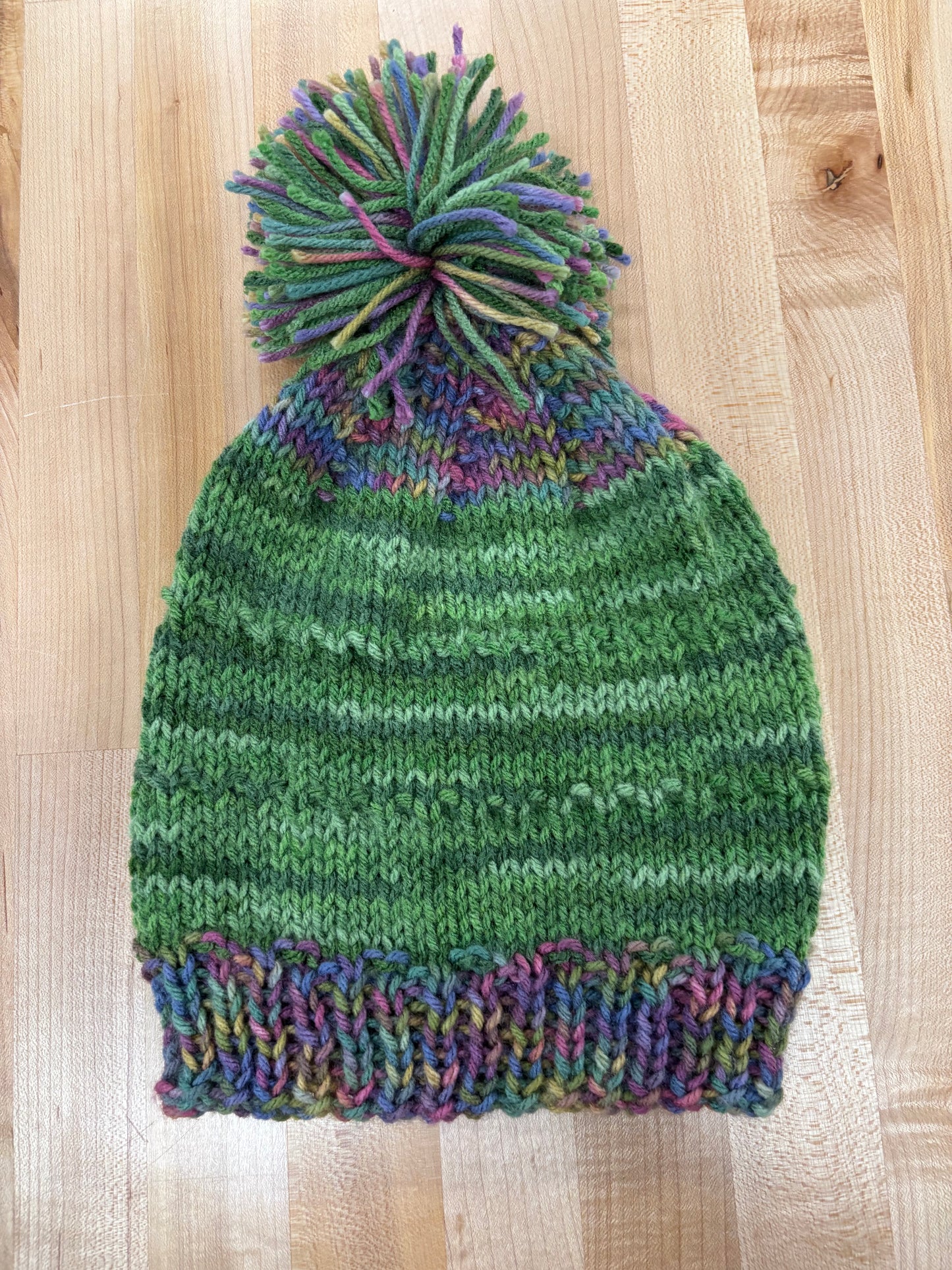 Hand knit winter hat with pom-pom