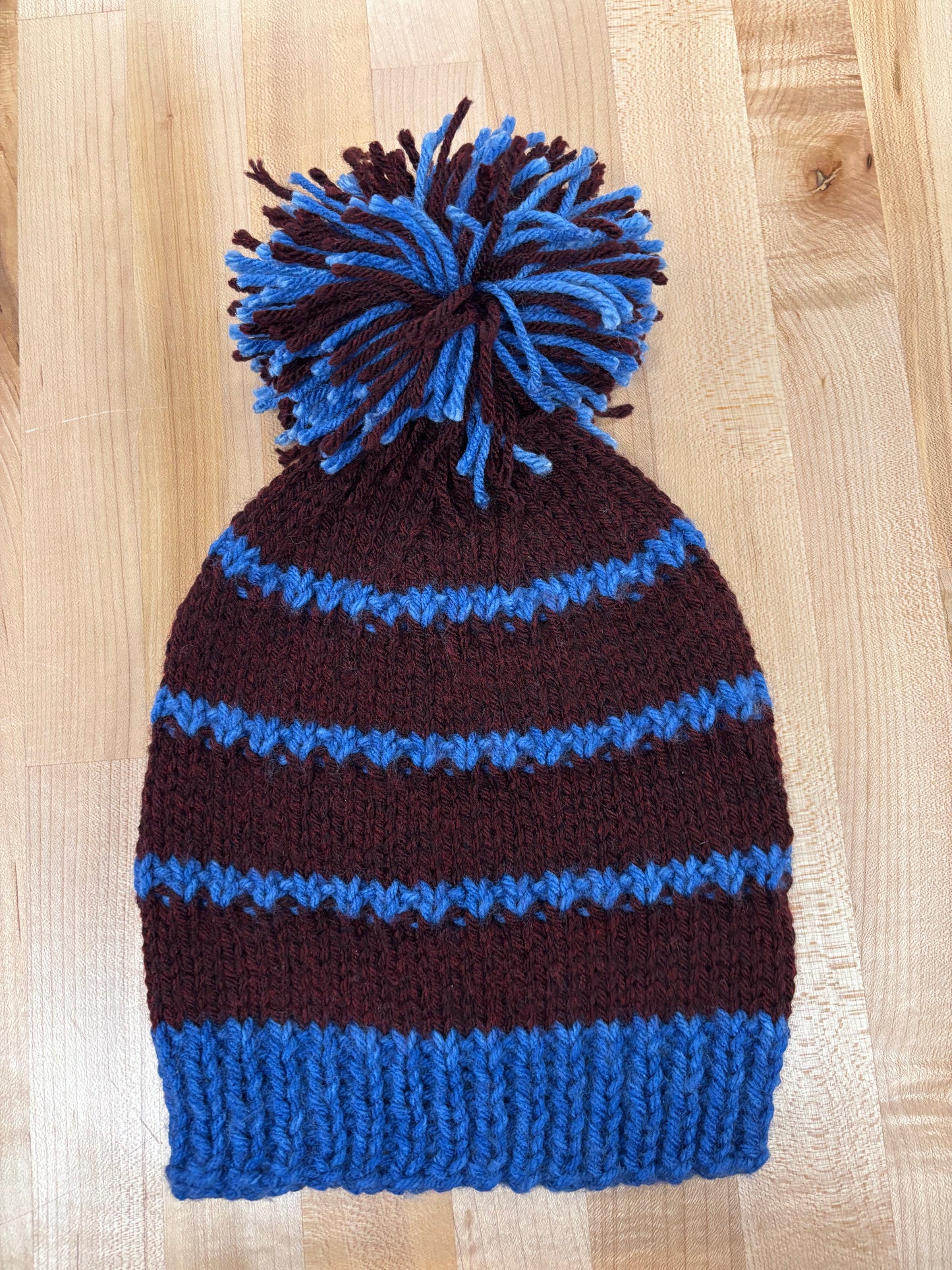 Hand knit winter hat with pom-pom