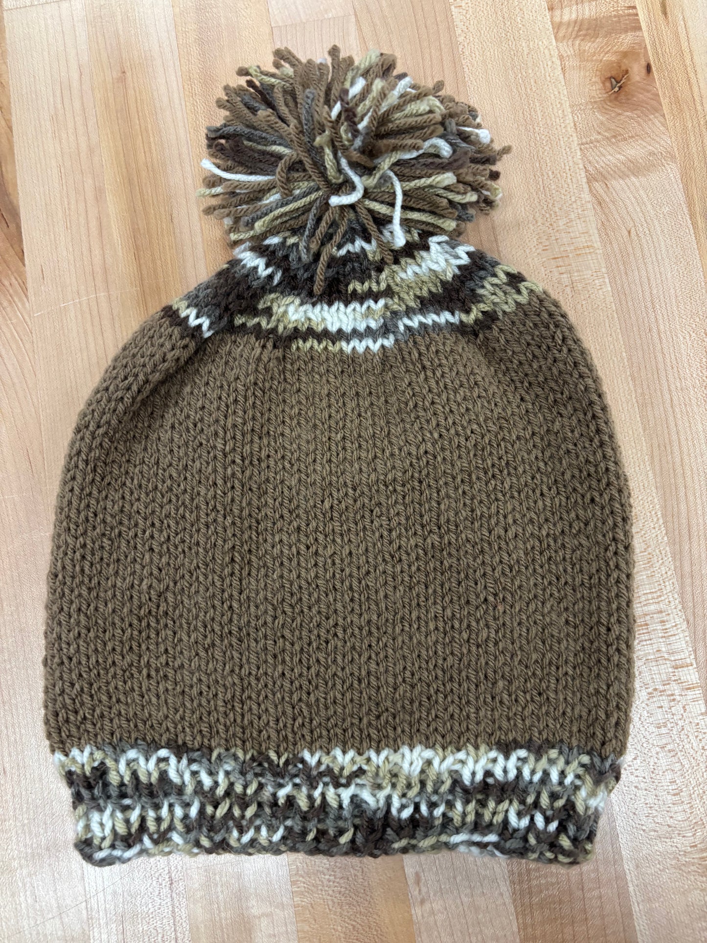 Hand knit winter hat with pom-pom