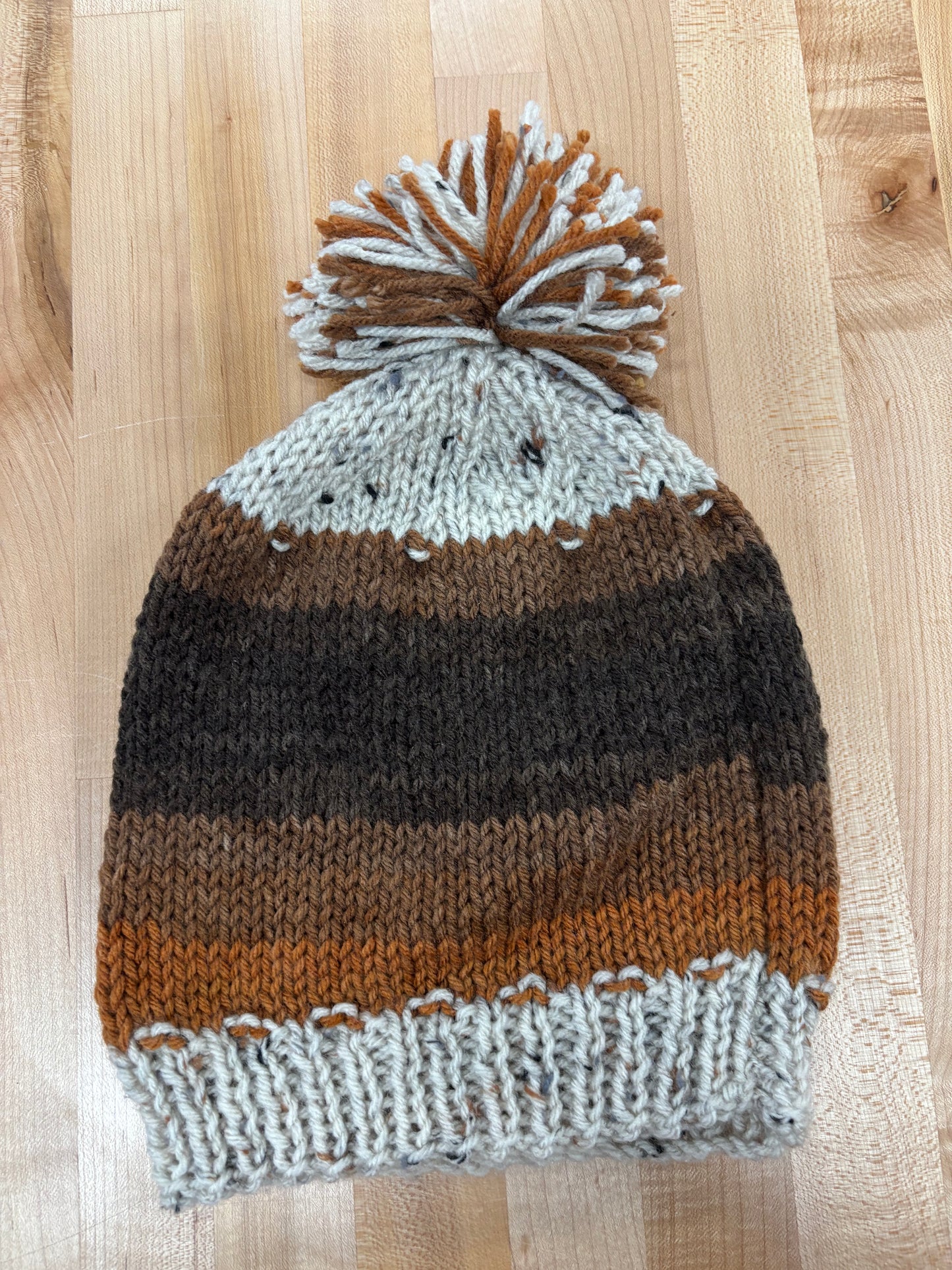 Hand knit winter hat with pom-pom